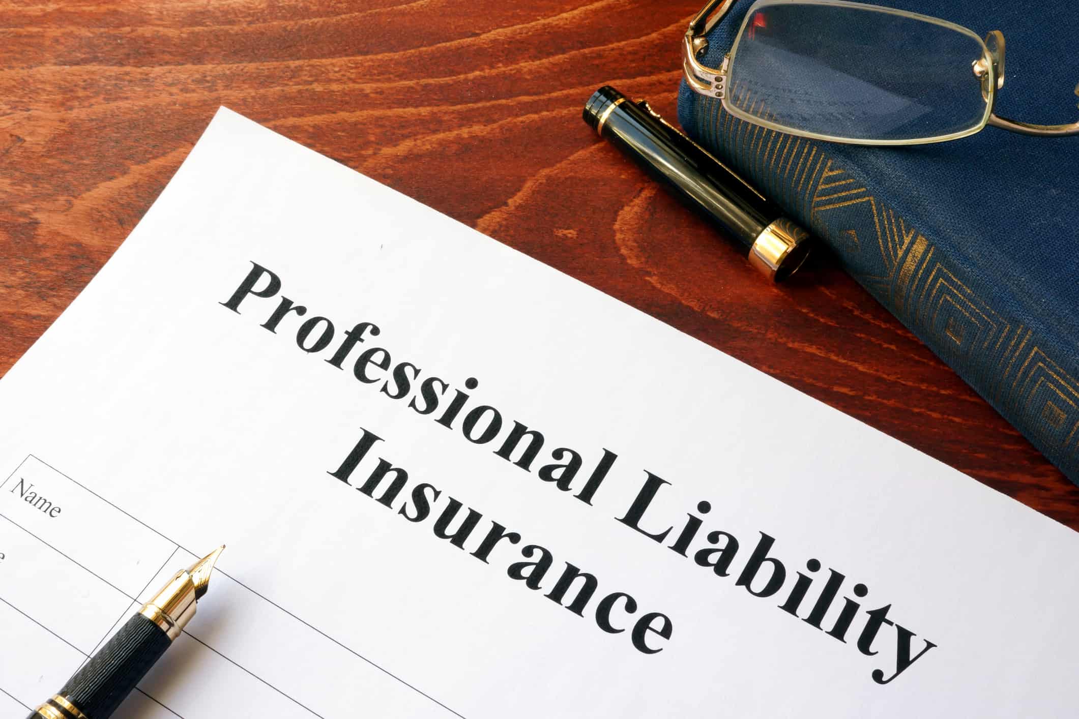 Professional liability insurance policy on a table.